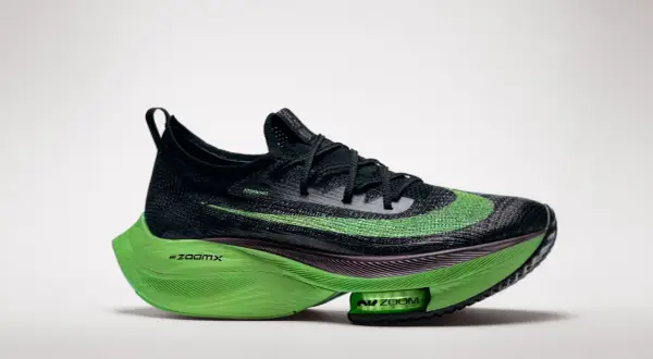 Schwarzer Laufschuh mit leuchtend grüner Sohle und Swoosh. Diese verbotene laufschuhe versprechen Höchstleistungen.
